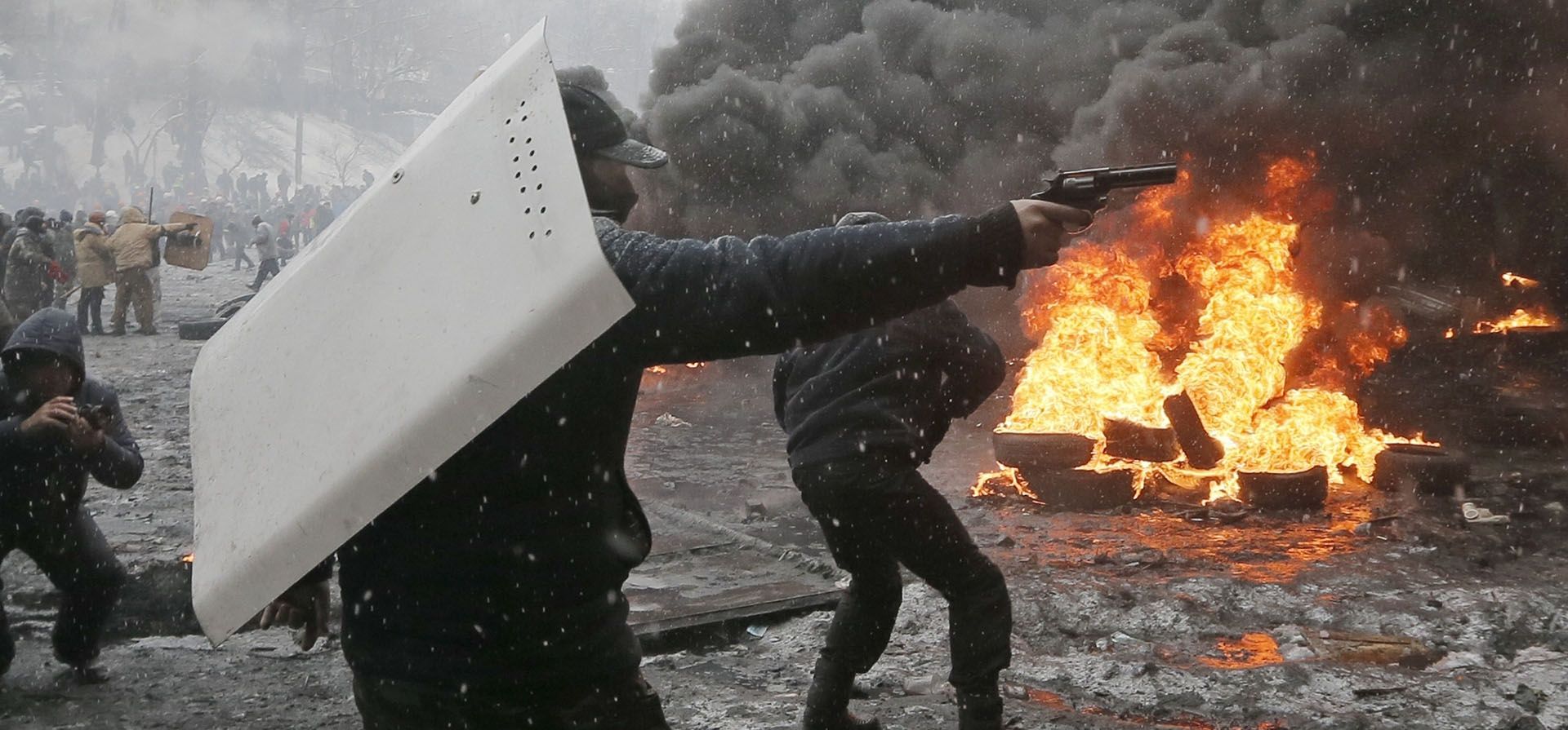 Fotografía del 22 de enero de 2014 de un manifestante apuntando con una pistola durante un enfrentamiento con la policía en el centro de Kiev, Ucrania. (AP Foto/Efrem Lukatsky, Archivo) Fotografía del 22 de enero de 2014 de un manifestante apuntando con una pistola durante un enfrentamiento con la policía en el centro de Kiev, Ucrania. (AP Foto/Efrem Lukatsky, Archivo)