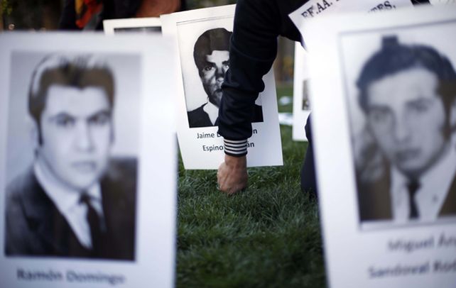 Pavoroso. Un hombre coloca la foto de un desaparecido. El acto recordatorio del golpe militar se realizó el 11 de septiembre frente al Palacio Presidencial.