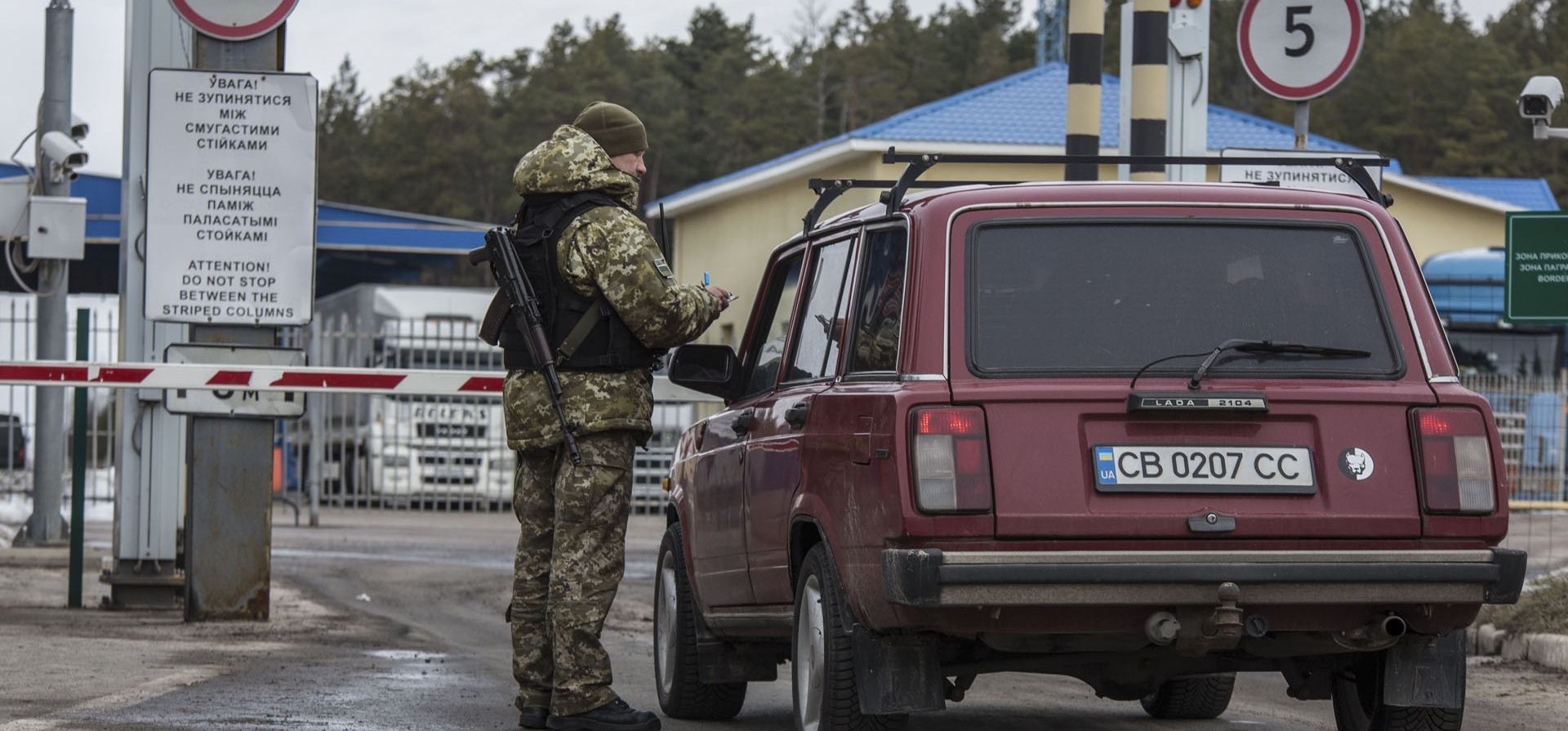 Un oficial de la guardia fronteriza ucraniana revisa un automóvil en el puesto de control fronterizo estatal bielorruso ucraniano Novi Yarylovychi, Ucrania, el lunes 21 de febrero de 2022.