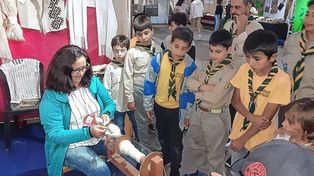 Pasión por enseñar. María del Carmen con la rueca, en una muestra de hilado ante los estudiantes.