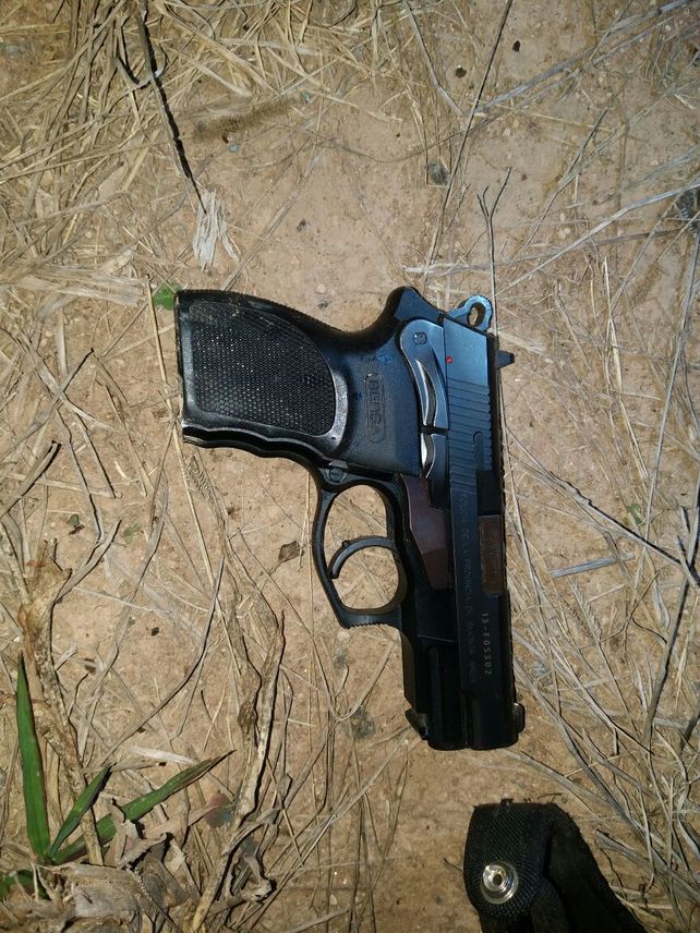 El arma reglamentaria de la mujer herida.