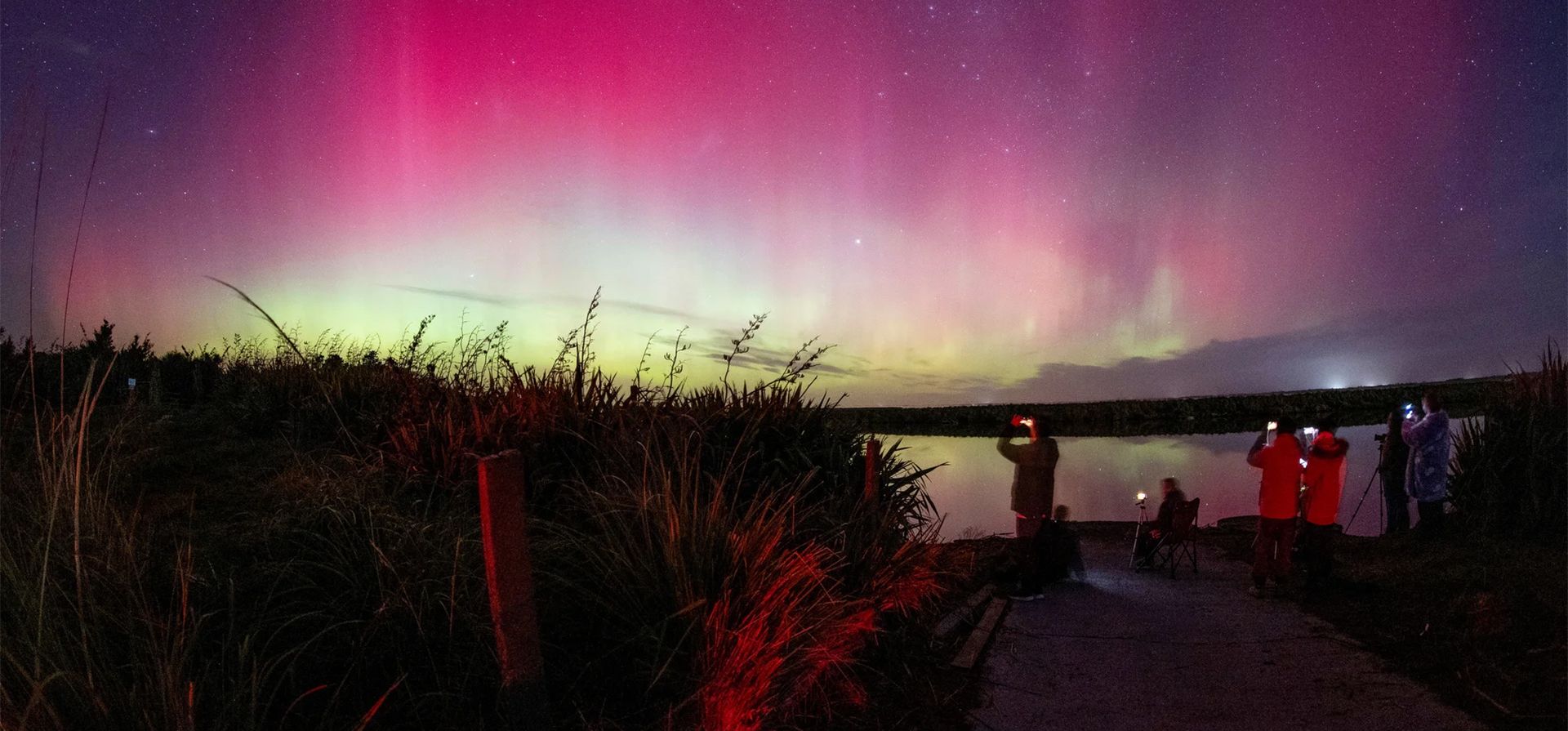 La gente toma fotos de la aurora austral, también conocida como las luces del sur, mientras brilla en el horizonte sobre el lago Ellesmere en Lincoln, Christchurch, Nueva Zelanda. Fotografía: Sanka Vidanagama/AFP/Getty Images La gente toma fotos de la aurora austral, también conocida como las luces del sur, mientras brilla en el horizonte sobre el lago Ellesmere en Lincoln, Christchurch, Nueva Zelanda. Fotografía: Sanka Vidanagama/AFP/Getty Images