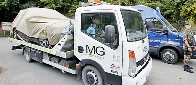 Un camión lleva el auto donde fue acribillado un matrimonio