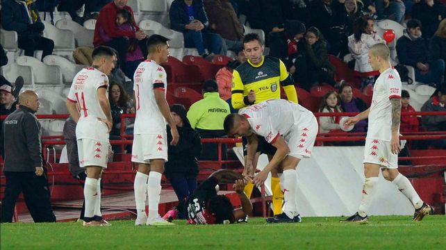 Recalde quedó tendido por la plancha de Valentín Sánchez y lo atienden los jugadores de Huracán. Lobo Medina mira como si nada. Debió salir el paraguayo.