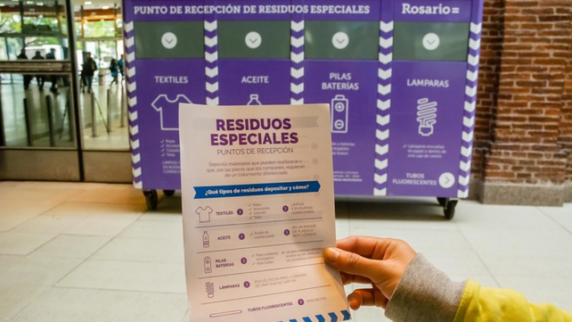 El contenedor violeta está en el ingreso al hipermercado.
