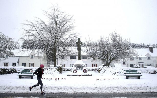 Una mujer trota en la nieve en Braco, cerca de Dunblane, Escocia. Se prevé que fuertes nevadas y lluvia helada azotarán el Reino Unido durante esta semana.
