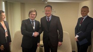 El presidente Milei estrecha su mano con el ex primer ministro del Reino Unido, David Cameron.