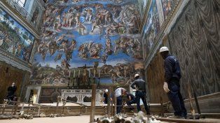 Trabajadores del Vaticano frente a los frescos del Juicio Final pintados por Miguel Ángel Buonarroti en la Capilla Sixtina.