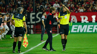 Pablo Echavarría echa a Gabriel Heinze en el partido entre Newells y Central Córdoba. El línea Julio Fernández, que sancionó offside, mira desde cerca.