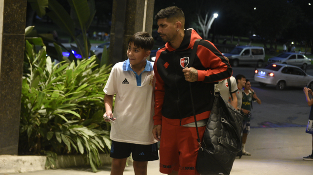 Ever Banega posa con un chico para la foto antes de entrar al hotel donde concentró Newell's.