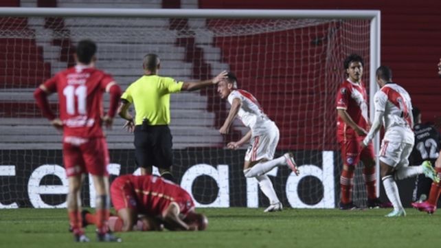 Braian Romero festeja su primer gol y Quintana sufre su resbalón desde el piso.