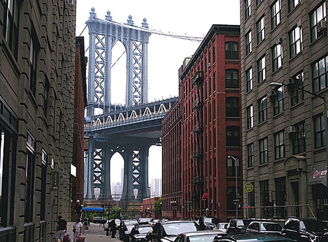 En el fondo de la calle emerge el puente de Manhattan