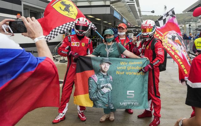 Espectadores vestidos con trajes de piloto posan para una foto durante una caminata previa a la carrera en el circuito Autodrom de Sochi, en Sochi, Rusia, el jueves 23 de septiembre de 2021. El Gran Premio de Fórmula Uno de Rusia se llevará a cabo el domingo.