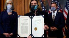 La presidenta de la Cámara de Representantes, Nancy Pelosi, muestra el pedido de juicio firmado. La presidenta de la Cámara de Representantes, Nancy Pelosi, muestra el pedido de juicio firmado.