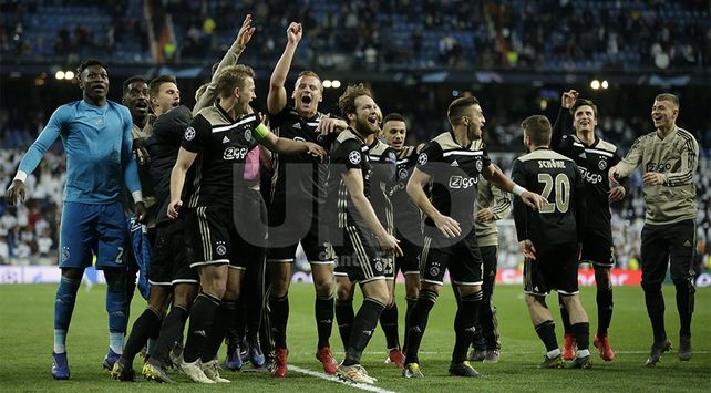 Ajax players celebrate after the Champions League round of 16 second leg soccer match between Real Madrid and Ajax at the Santiago Bernabeu stadium in Madrid