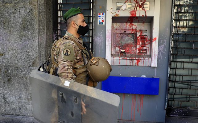 Un cajero automático dañado durante las protestas de los padres de estudiantes libaneses en el extranjero y exigen que los bancos permitan la transferencia de tasas universitarias para sus hijos