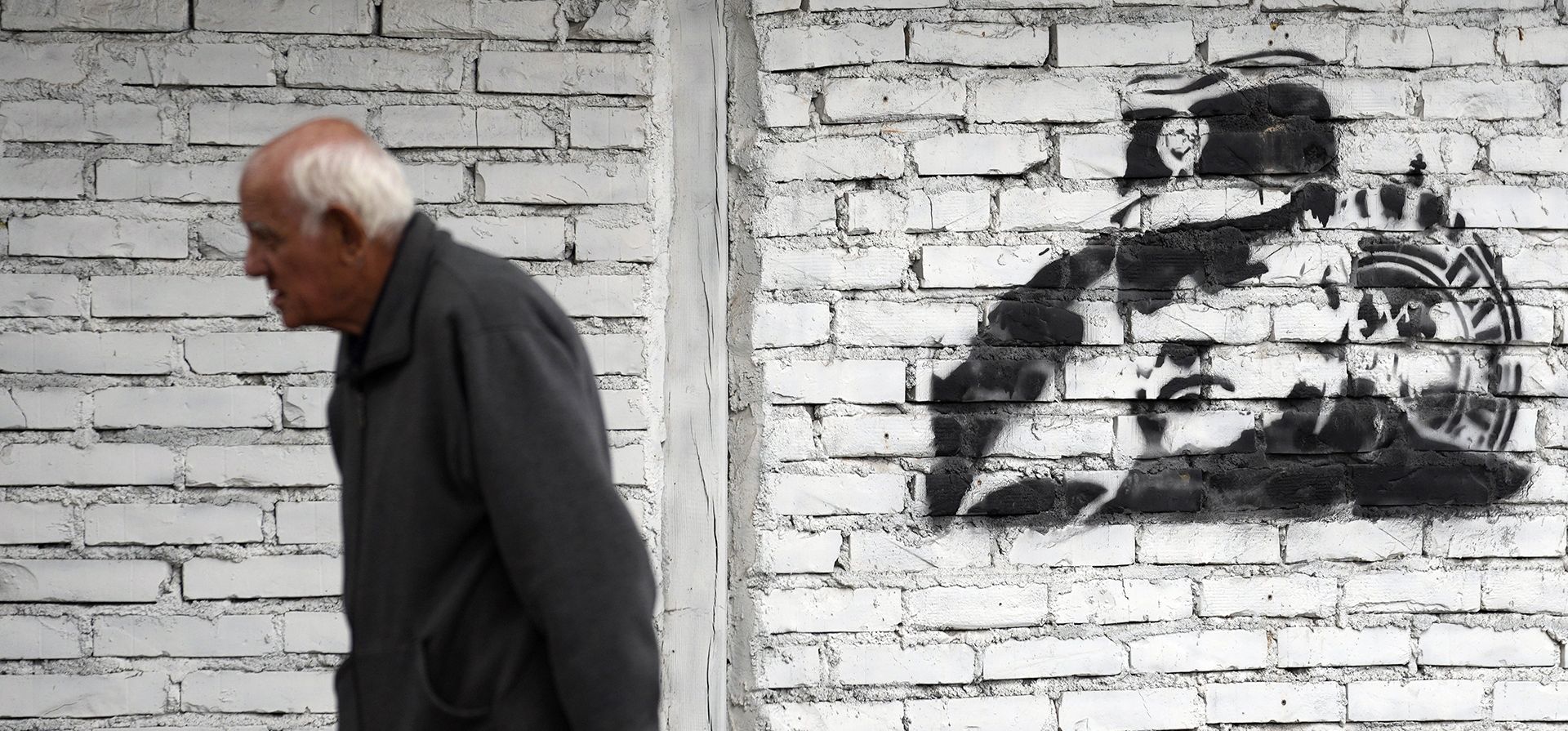 Un hombre camina junto a un mural que representa al exjefe militar serbobosnio Ratko Mladic en Belgrado, Serbia, el martes 20 de septiembre de 2022. Mladic cumple cadena perpetua por genocidio durante la guerra de 1992-1995 en Bosnia, pero muchos serbios todavía lo consideran un héroe.